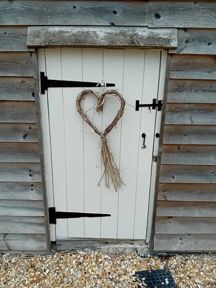 A heart shaped door with a rope attached to it.
