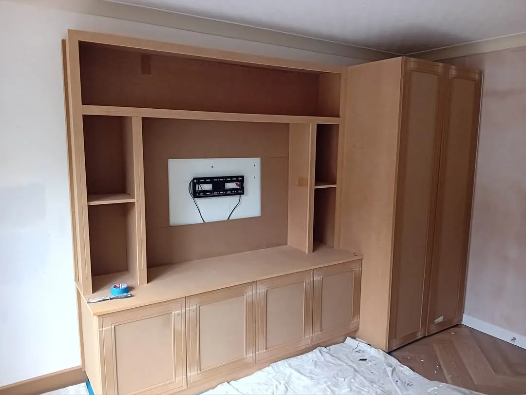 A living room with a built in entertainment center.