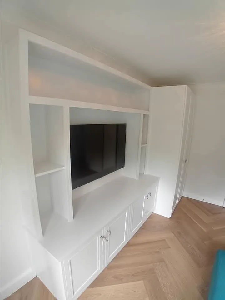 A white entertainment center with a flat screen tv.