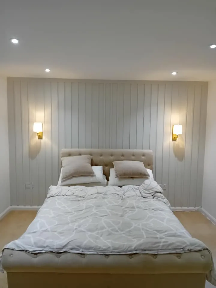 A large bed sitting in a bedroom next to two lamps.