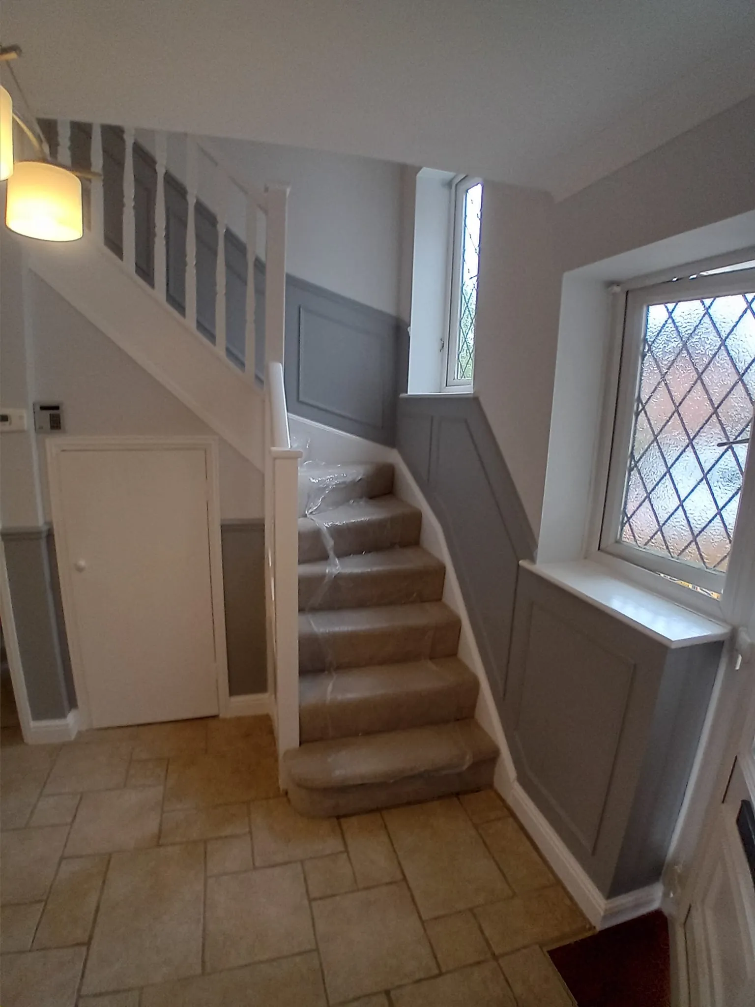 A staircase leading up to a window in a house.