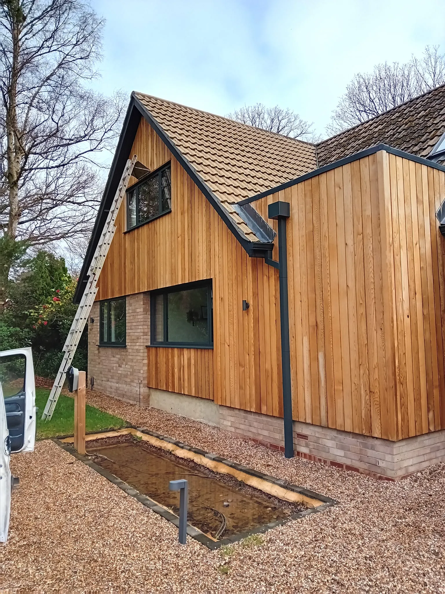 A house with a ladder attached to the side of it.