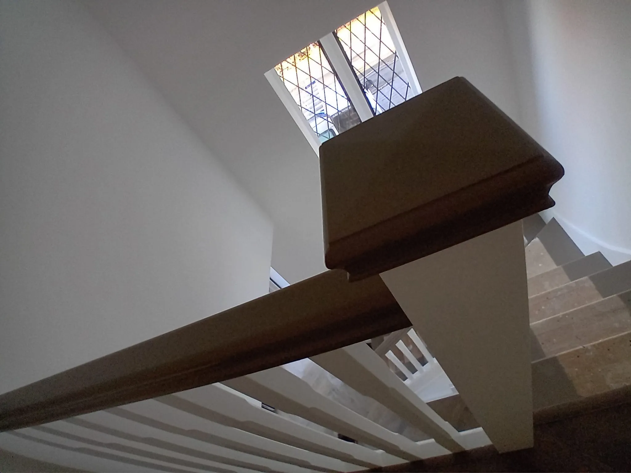 a staircase with a window and a light