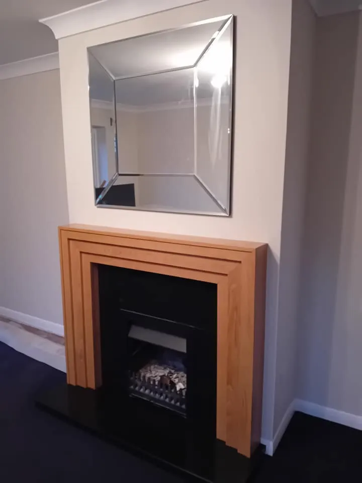 a fireplace with a mirror above it