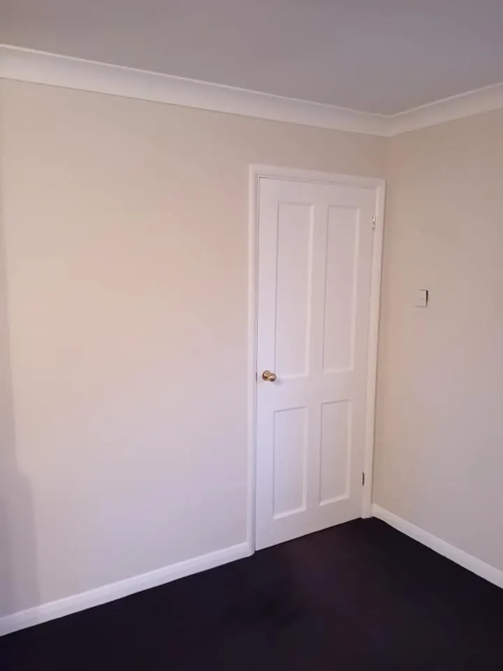 a room with a door and a black floor