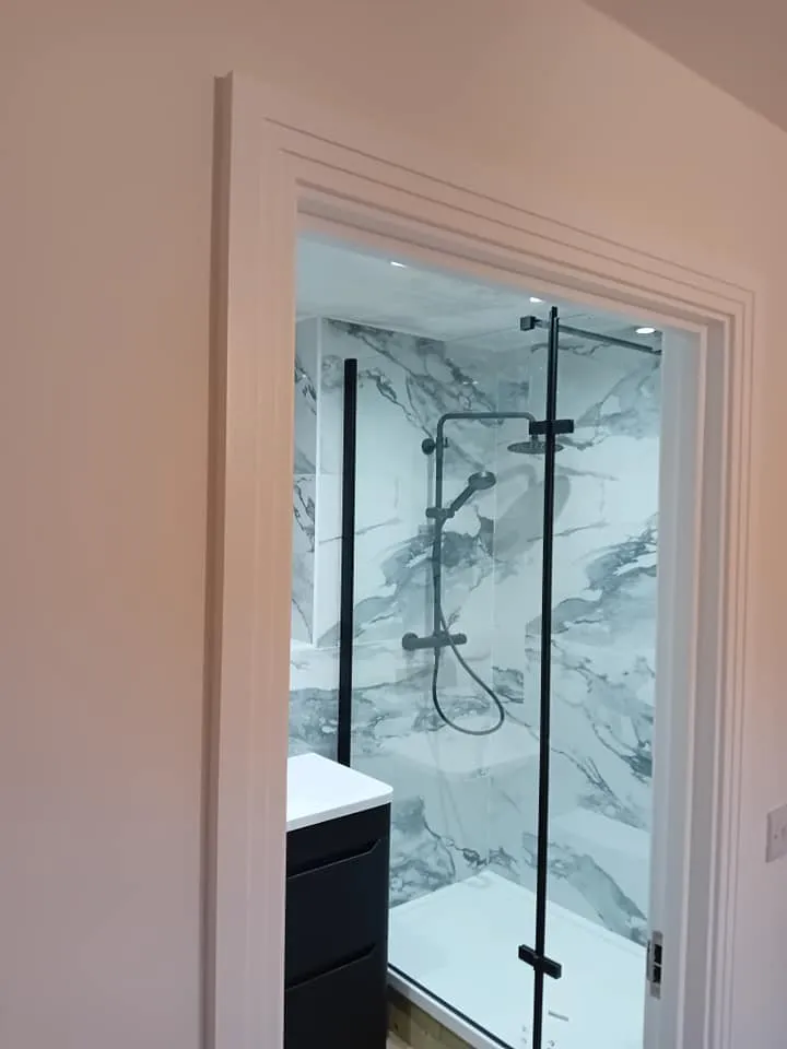 a bathroom with a shower and a sink