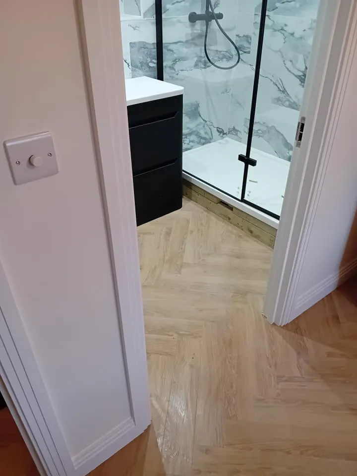 a bathroom with a shower and a sink