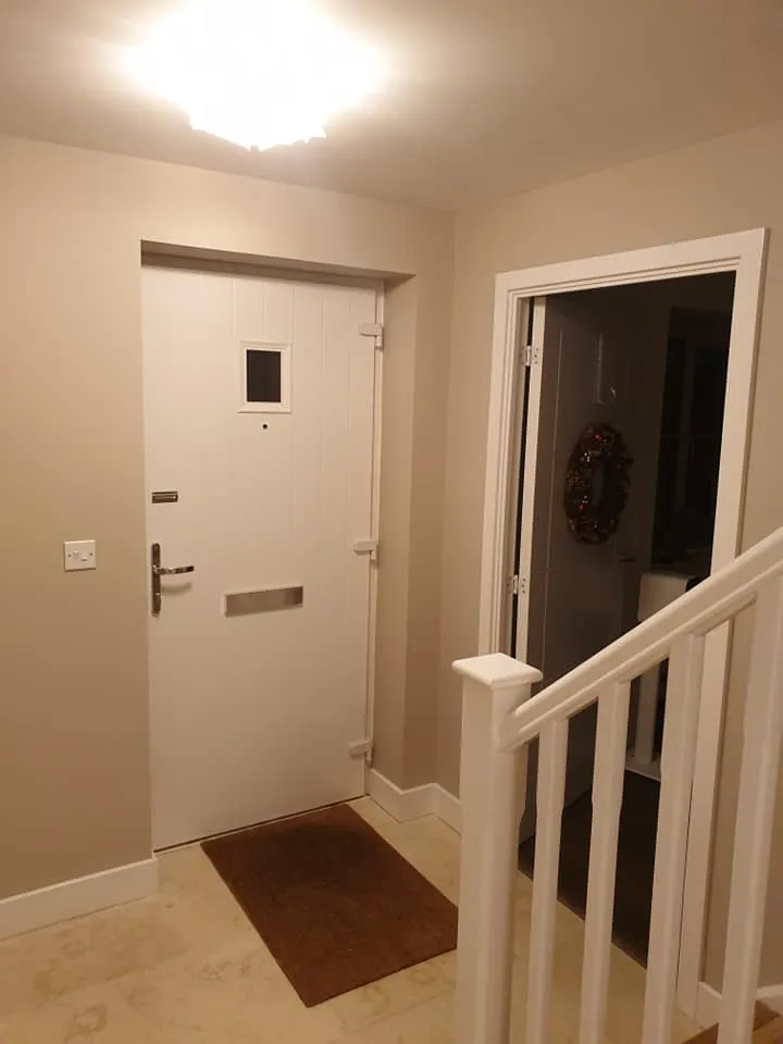 a white door and some stairs in a room
