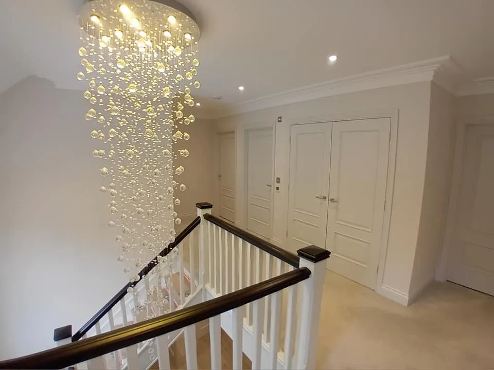 a staircase with a chandel light fixture