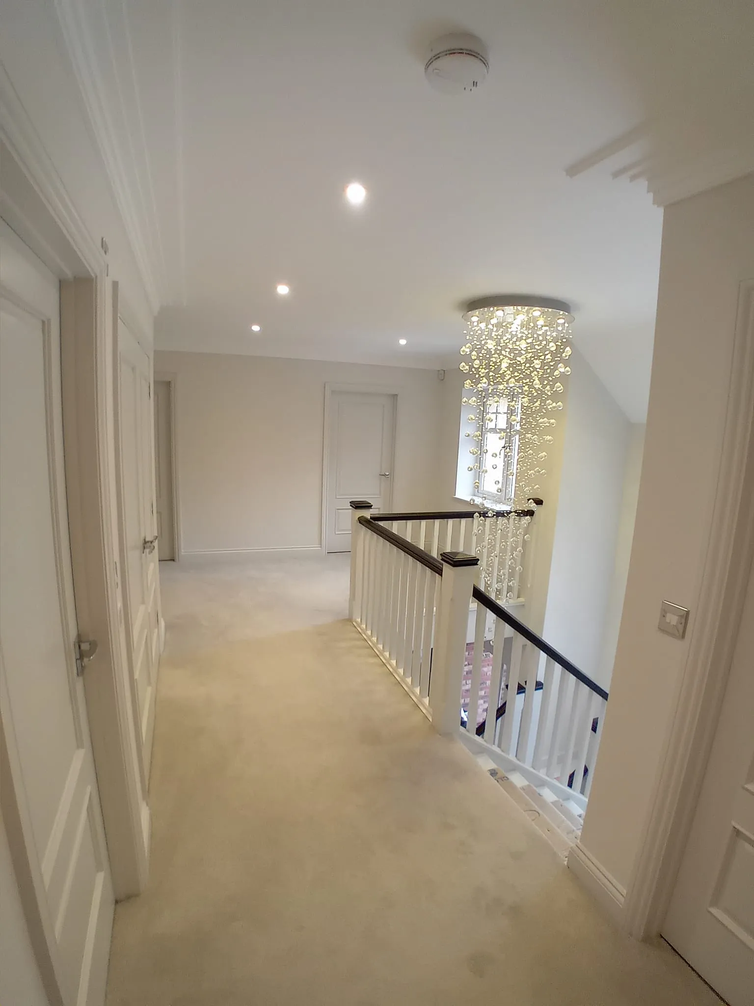 a hallway with a chandel and a chandel