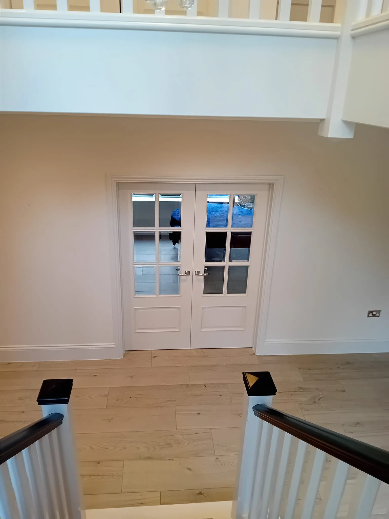 a white door and some stairs in a house