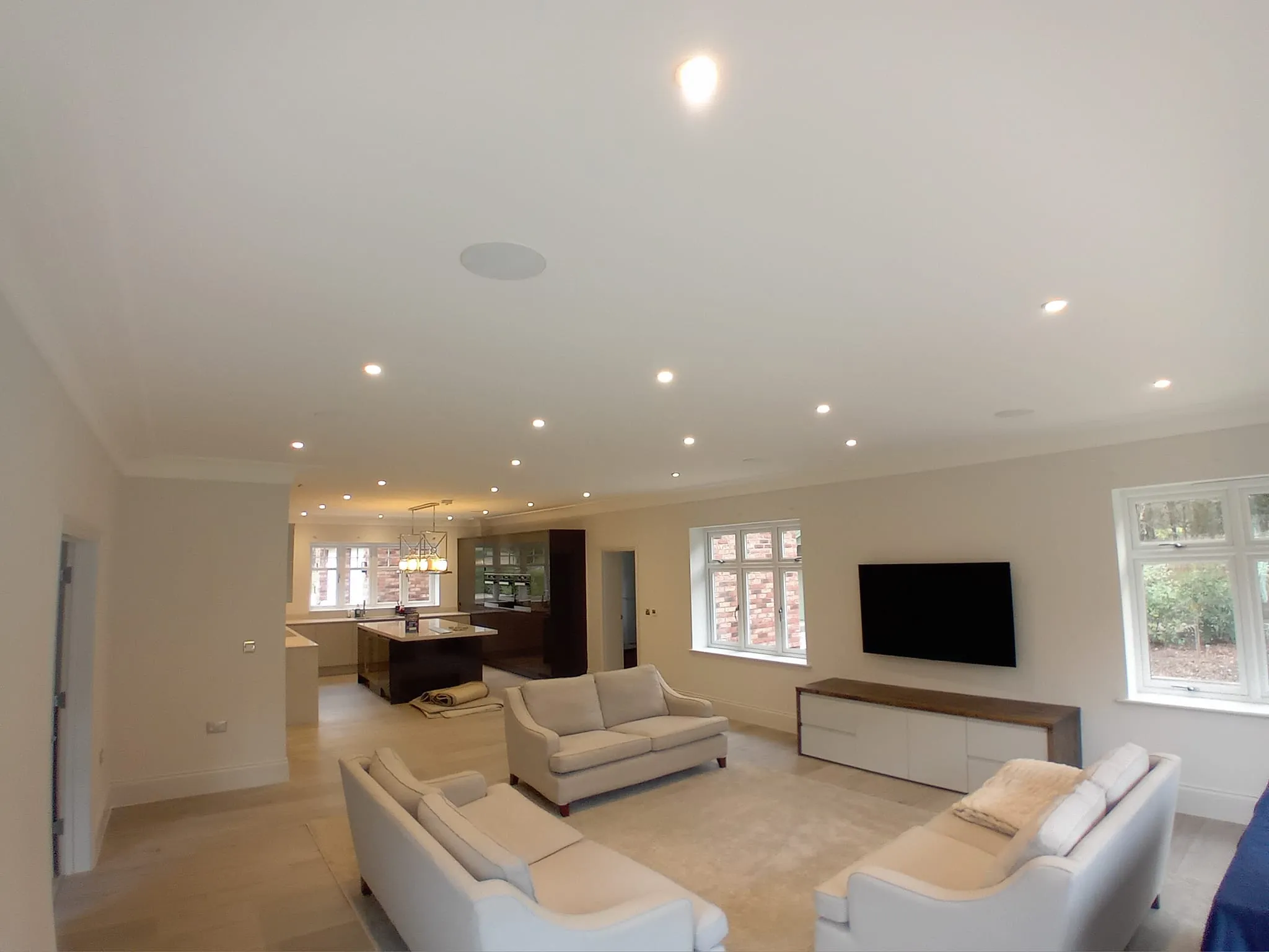 a living room with white furniture and a flat ceiling